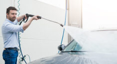 a man washes his car at a self-service car wash