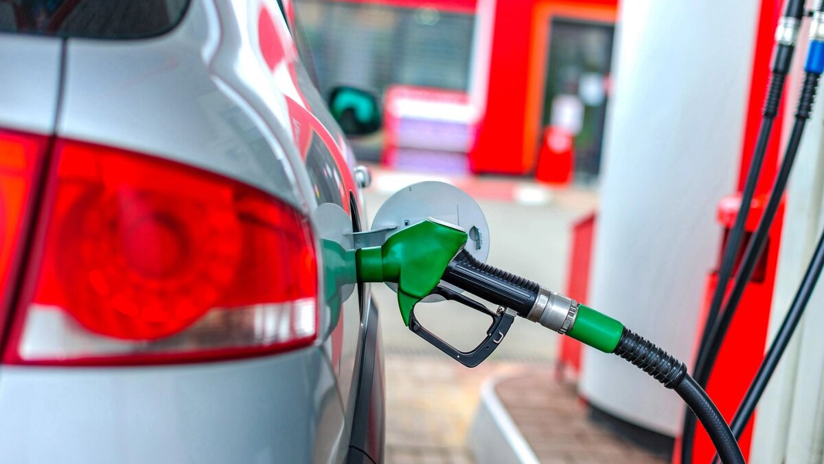 a car is refueled at a gas station