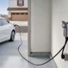 An electric car is being charged at a charging station