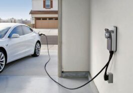 An electric car is being charged at a charging station