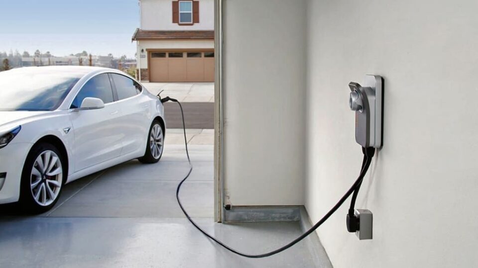 An electric car is being charged at a charging station