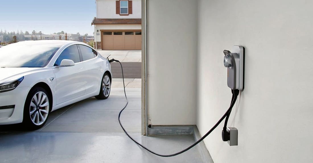 An electric car is being charged at a charging station