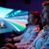 men participate in a virtual Formula 1 race