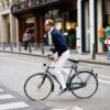 A man rides a bicycle in an urban environment