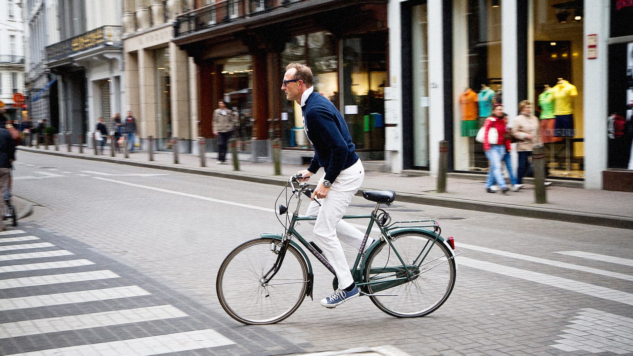 A man rides a bicycle in an urban environment