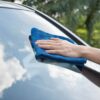 washing the windshield of a car