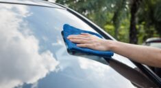 washing the windshield of a car