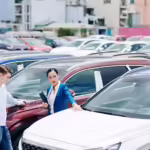 man and woman looking at second hand cars